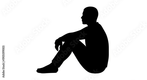 Silhouette of a man sitting on the ground in profile view.