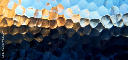 Abstract frosted glass texture with blue and golden light refraction. Modern honeycomb geometric pattern and soft bokeh distortion, perfect for technology backgrounds and web design