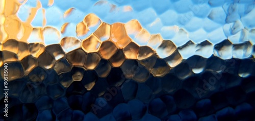 Abstract frosted glass with techno futurism light refraction. Modern honeycomb geometric pattern and blue gold bokeh distortion, ideal for futuristic technology and web backgrounds