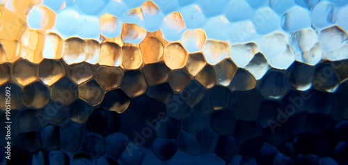 Abstract frosted glass with techno futurism light refraction. Modern honeycomb geometric pattern and blue gold bokeh distortion, ideal for futuristic technology and web backgrounds