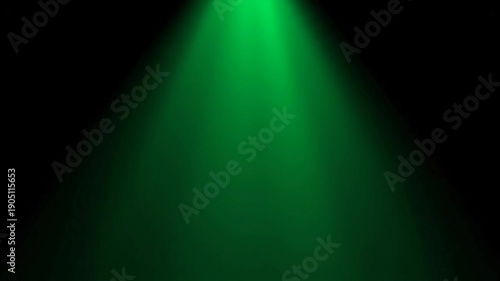 Green Spotlight Beam Shining Down on a Dark Background.