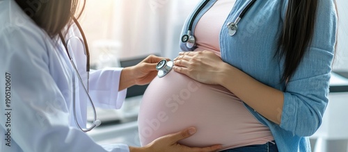 The doctor examines the pregnant woman with a stethoscope