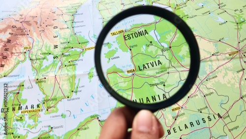 View of Latvia, officially the Republic of Latvia, is a country in the Baltic region of Northern Europe, on a geographical map of Europe, seen using a magnifying glass