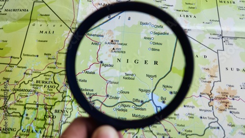 View of Niger, officially the Republic of Niger, is a landlocked country in West Africa., on a geographic map of Africa, seen using a magnifying glass