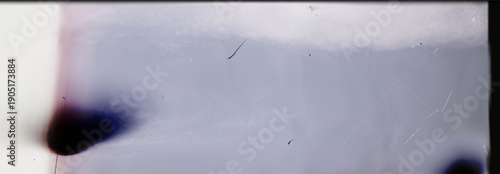 Abstract vector illustration of vintage 35mm film scan with blue color wash cinematic light leaks and grainy texture featuring retro dust scratches and analog film burn effect