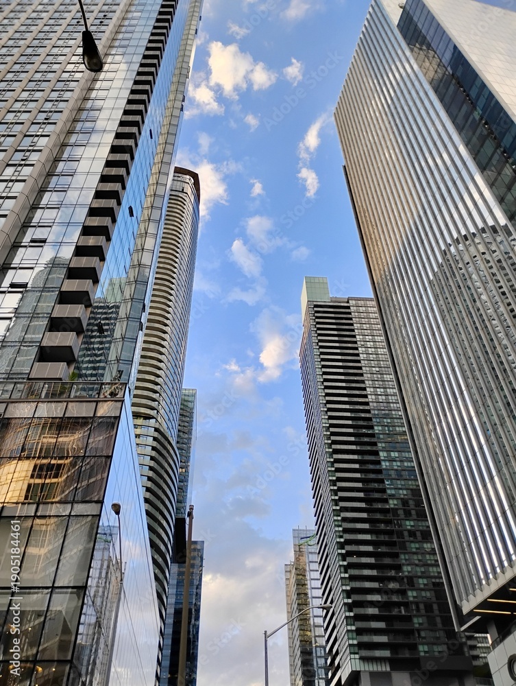 Naklejka premium Toronto, Ontario, Canada - June 21, 2025: Downtown Toronto skyline looking upward
