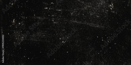 A heavily distressed and scratched dark surface with textural imperfections and scattered light specks throughout