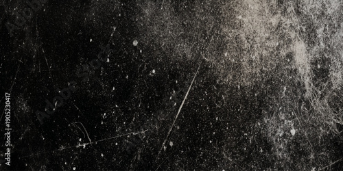 A textured dark grayscale image featuring scratches dust and light imperfections evoking a vintage aesthetic