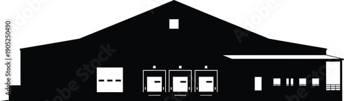 Industrial building with gable roof and multiple windows viewed from the front facade