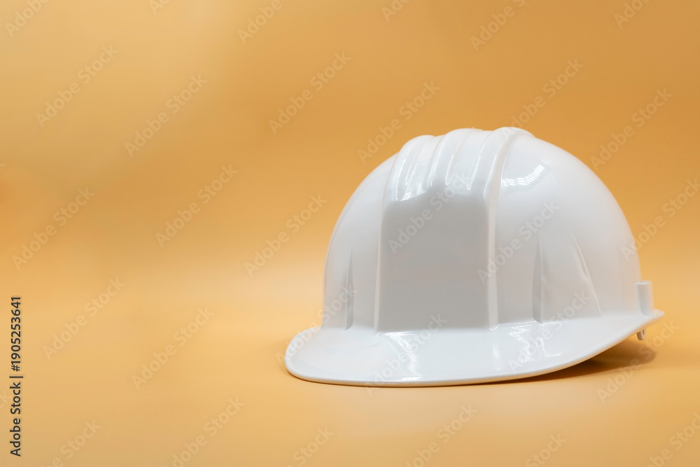 Fototapeta premium White Safety Helmet Isolated on Yellow Background