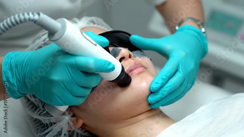 Wallpaper Mural Facial Skin Treatment with Laser Procedure on Young Woman with Black Eye Protection and Gloved Hands in Beauty Clinic Torontodigital.ca