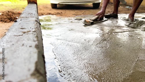 Worker Smoothing Cement for Building Foundatio
