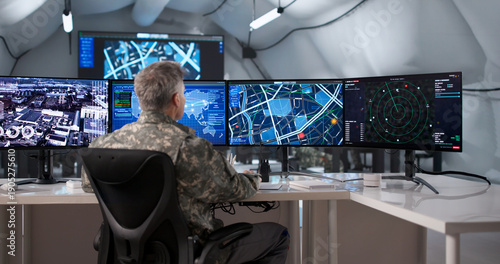 Schilderij op canvas Military Officer Monitoring Surveillance Data On Desktop Computer