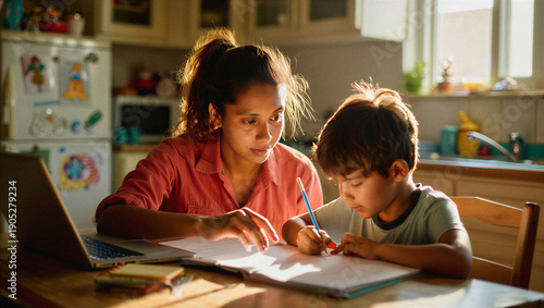 Mother teaching son at home with laptop during homeschool lesson. Concept of work from home parenting, elementary education support, and authentic domestic learning.