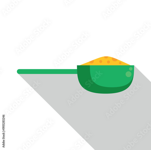 Green measuring scoop full of yellow washing powder with a long shadow