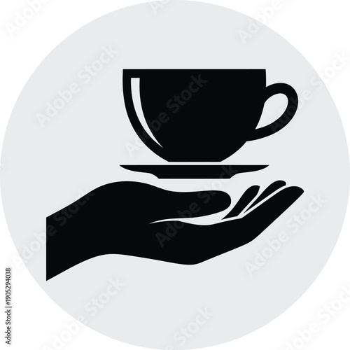 A hand holding a teacup and saucer