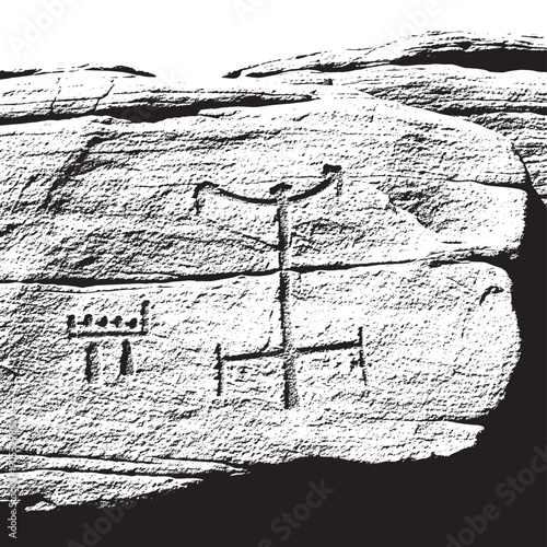 Ancient petroglyph engraving on rock surface depicting humanoid figure.