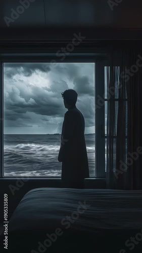 Melancholy by the Shore: A lone figure, silhouetted by the stormy sea viewed through the window, captures the essence of solitude and contemplation.