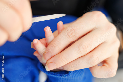 Mom uses a file to clean her sun`s nails
