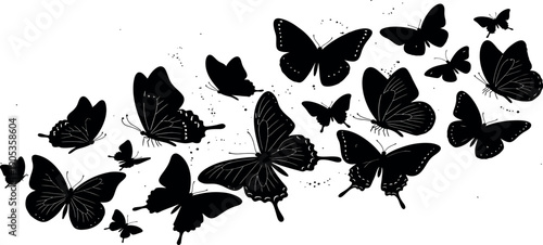 Silhouette of a flock of butterflies flying together in a chaotic pattern