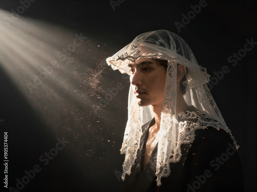 Intense volumetric lighting on man wearing bridal veil with calm face