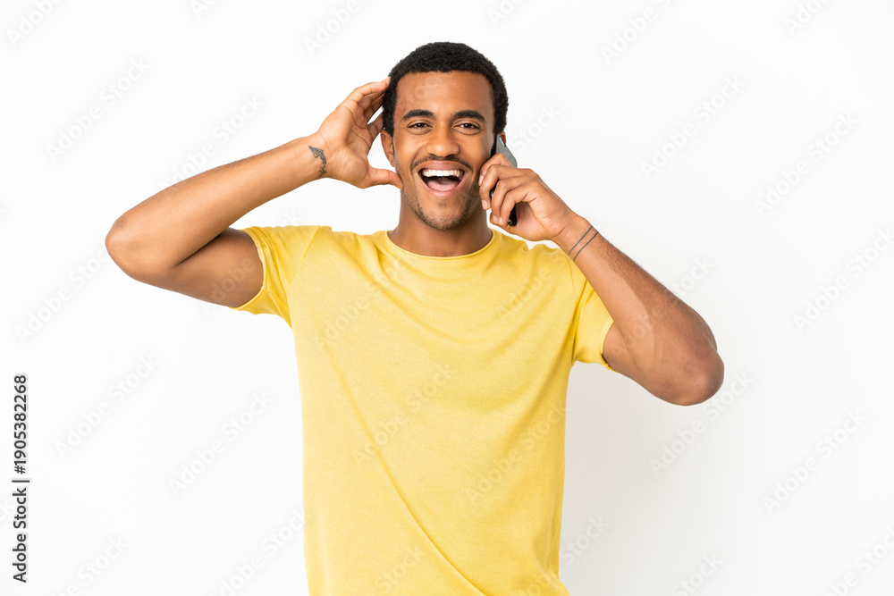 Fototapeta premium African American handsome man using mobile phone over isolated white background with surprise expression