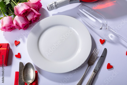 Fresh pink roses and place setting on white background, copy space
