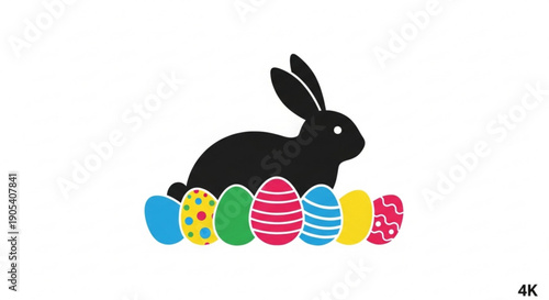 Black silhouette rabbit sitting with colorful easter eggs in a row on white background