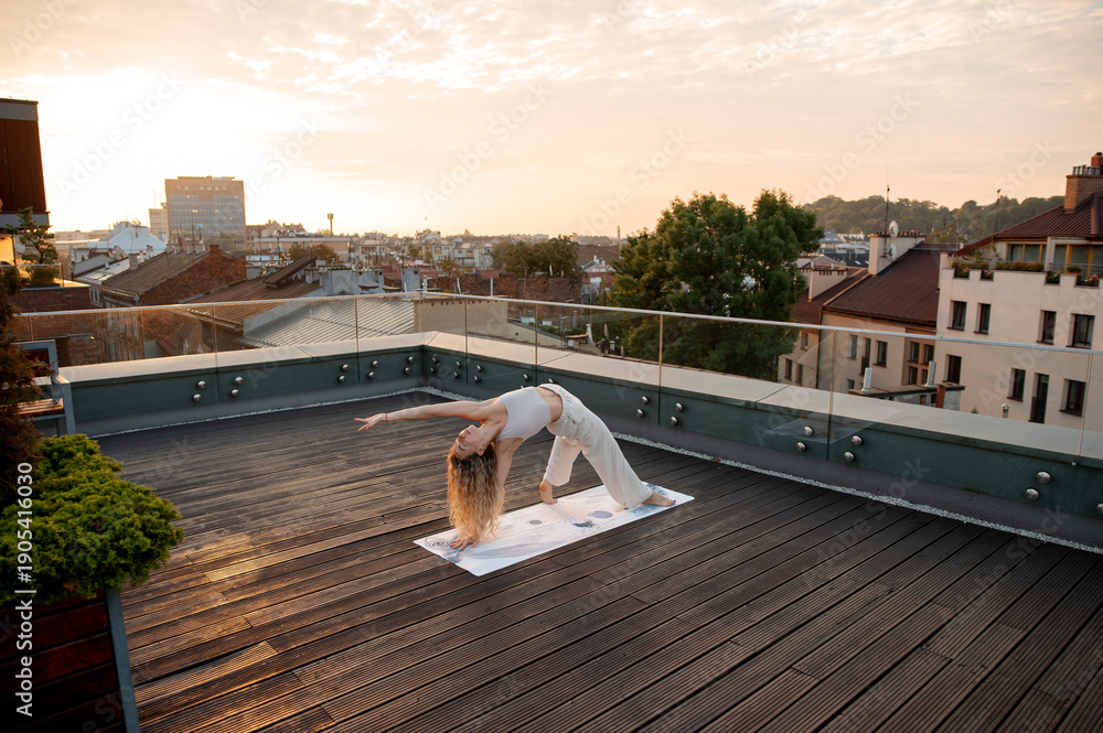 Naklejka premium Woman Yoga Pose On Rooftop