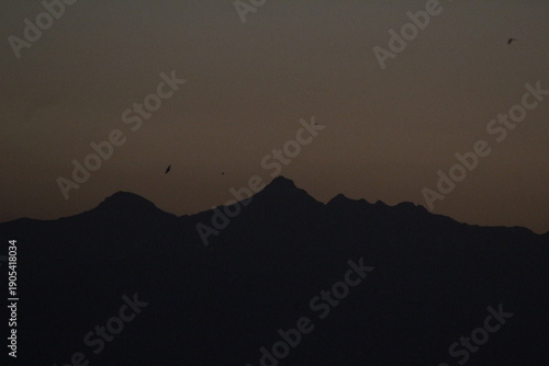 Mountain silhouettes against a dusky sky