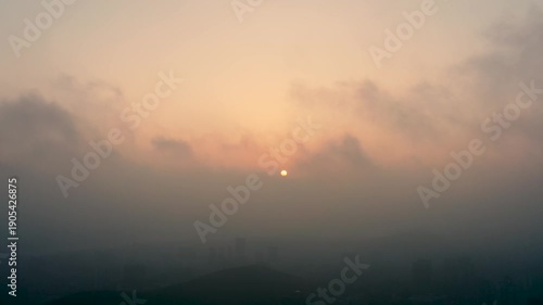 Aerial City Sunset Through Fog and Clouds
