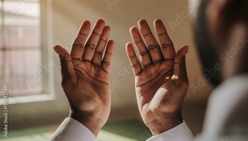 Close-up of a person's hands uplifted in a sacred gesture of prayer and devotion, seeking spiritual guidance and expressing heartfelt faith in a moment of quiet reflection and worship