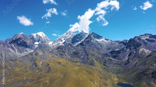 Alpine Mountain Range with Snow Peaks and Autumn Grassland Valley
