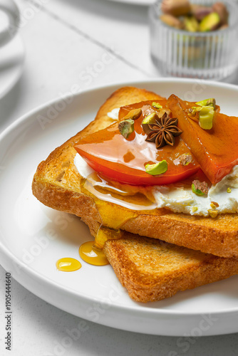 Toast with persimmon and cream cheese for breakfast close-up
