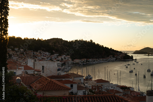 Poros Island bay and harbor view with traditional seaside town and calm Mediterranean waters, Greece.