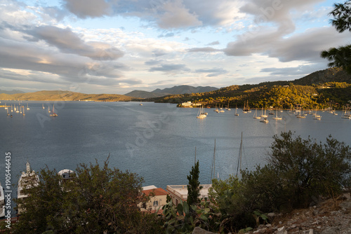 Poros Island bay and harbor view with traditional seaside town and calm Mediterranean waters, Greece.