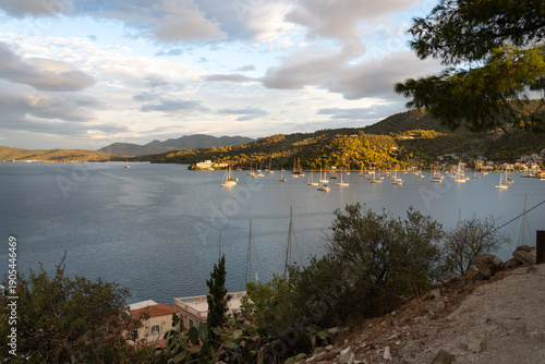 Poros Island bay and harbor view with traditional seaside town and calm Mediterranean waters, Greece.