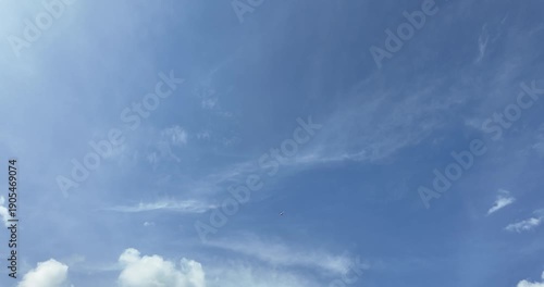Blue sky with white clouds and sun rays.