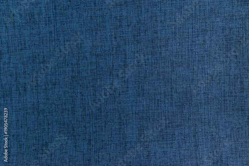 Blue fabric texture background. Macro shot of dark blue linen cloth material. Detailed textile weave pattern for apparel fashion or professional interior design backdrop.