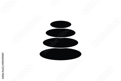 Stack of balanced black stones for zen spa meditation and massage concept
