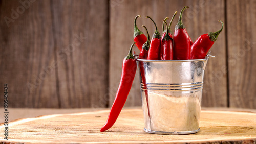Fotografie Red chili peppers in a decorative bucket