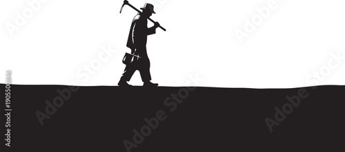 Silhouette of a man walking with pickaxe and shovel