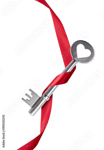 Red silk ribbon winds through a key bow shaped like a heart. Close up image. Isolated on white transparent PNG background. Symbol for love, valentine, and wedding. 
