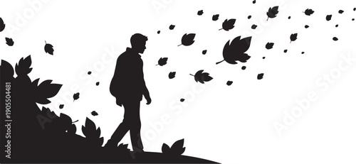 Silhouette of a man walking on a hill with leaves