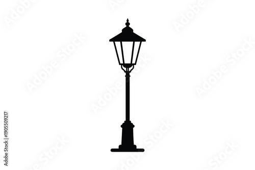 Black silhouette of old fashioned street lamp post with ornate base and top isolated on white background