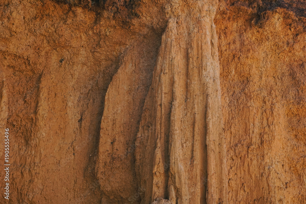 Naklejka premium Discover the raw beauty of ancient earth pillars and canyons, sculpted by centuries of natural erosion into a dramatic, sun-drenched landscape of rugged geological wonder.