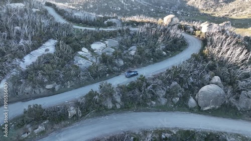 Mountain Off‑Road Challenge: Car Navigates Dusty, Rocky Uphill Terrain