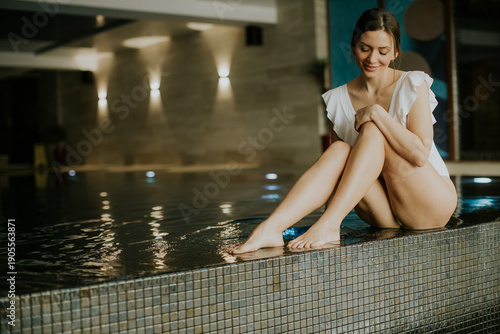 Woman sits by water in spa ...