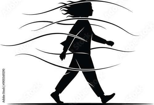 Silhouette of a woman walking with flowing hair and clothes in the wind
