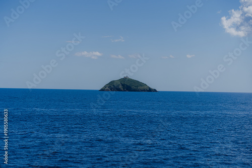 View of the island. A small island in the blue sea.